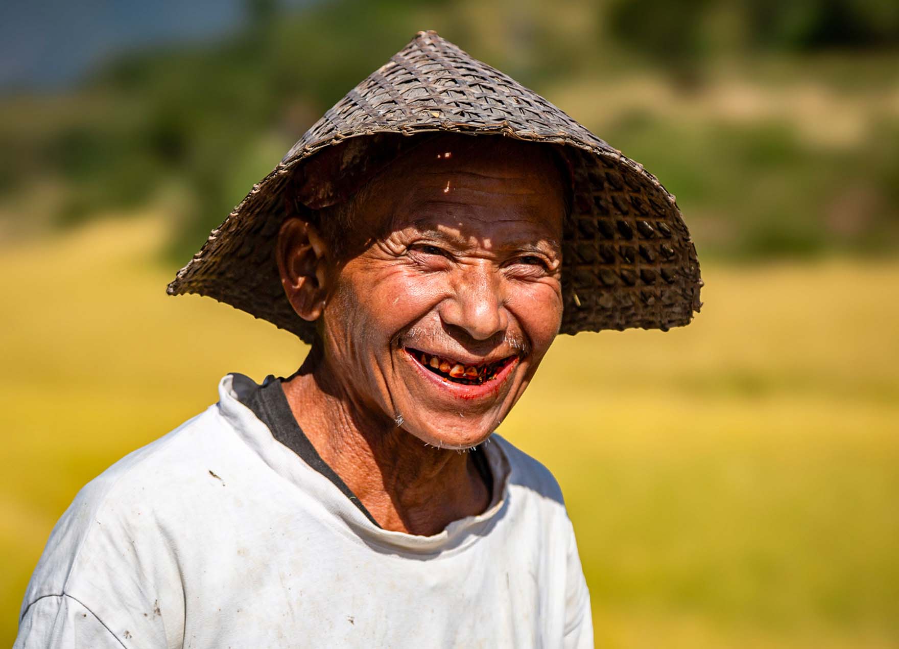 A Bhutanese farmer smiling in the countryside